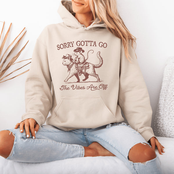 Take your fashion game to the wild frontier with our quirky and bold hoodie featuring a mouse riding a cat like a cowboy—both decked out in classic cowboy hats.